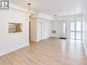 Richmond Hill (Mill Pond) condo for rent - A spacious room with wooden flooring and white walls.