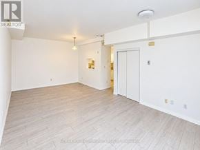 Richmond Hill (Mill Pond) condo for rent - A spacious room with white walls and a wooden floor.