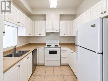 Richmond Hill (Mill Pond) condo for rent - A white kitchen with a refrigerator, sink, stove, and cabinets.