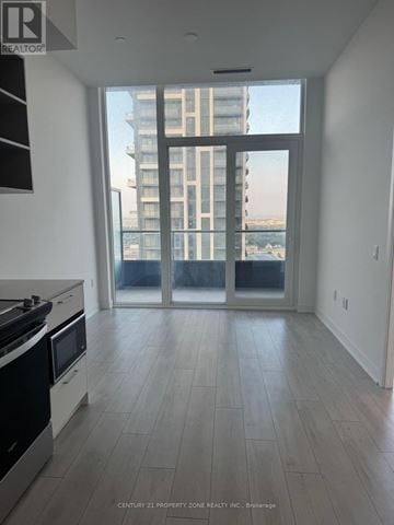 Brampton (Fletcher's Creek South) condo for rent - A kitchen with a stove top oven and a microwave.