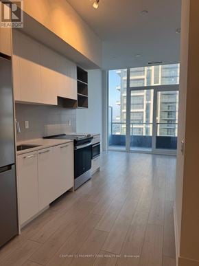 Brampton (Fletcher's Creek South) condo for rent - A kitchen with white cabinets and a stainless steel refrigerator.