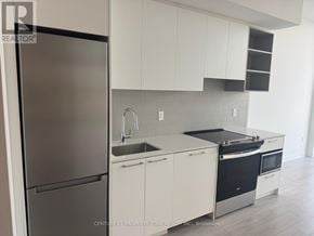 Brampton (Fletcher's Creek South) condo for rent - A modern kitchen with white cabinets and stainless steel appliances.