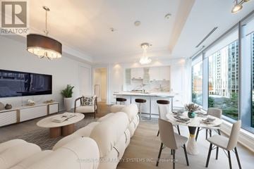 Toronto (Annex) condo for rent - A modern living room with a white sofa set and a dining table with chairs.