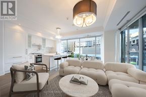 Toronto (Annex) condo for rent - A living room with a large sectional sofa and a coffee table with a book on it.