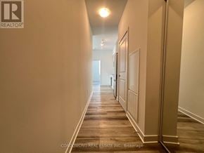 Vaughan (Concord) condo for rent - A long hallway with doors on both sides and a light at the end.