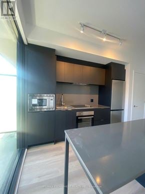 Hamilton (Beasley) condo for rent - A modern kitchen with dark cabinets and stainless steel appliances.