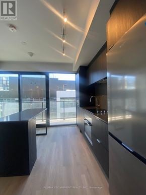 Hamilton (Beasley) condo for rent - A modern kitchen with stainless steel appliances and wooden accents.