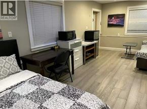 Vancouver apartment for rent - A bedroom with a bed, desk, and chair.