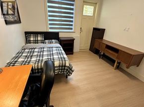 Richmond apartment for rent - A bedroom with a bed, desk, and chair.
