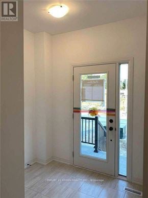 Barrie (Painswick South) townhouse for rent - A white door with a glass window and a black railing.