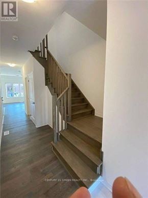 Barrie (Painswick South) townhouse for rent - A staircase with wooden steps and handrails.