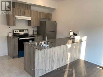 Barrie (Painswick South) townhouse for rent - A kitchen with a countertop and cabinets in a real estate listing.