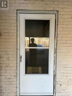 Hamilton (Landsdale) triplex for rent - A white door with a glass window is set in a brick wall.