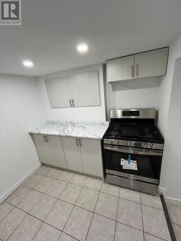 Hamilton (Landsdale) triplex for rent - A kitchen with a stove top oven and a counter top.