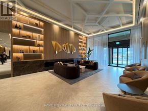 Vaughan (Concord) condo for rent - A modern lobby with a reception desk and seating area.