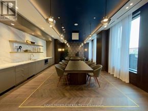 Vaughan (Concord) condo for rent - A modern dining room with a long table and chairs.