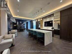 Vaughan (Concord) condo for rent - A modern living room with a long white table and chairs.