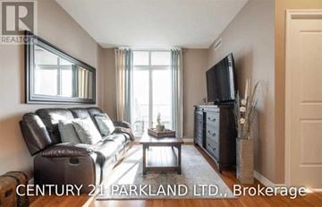 Vaughan (Maple) condo for rent - A living room with a leather couch and a flat screen TV.