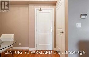 Vaughan (Maple) condo for rent - A white door is in the middle of a room with a glass table and a light switch on the wall.