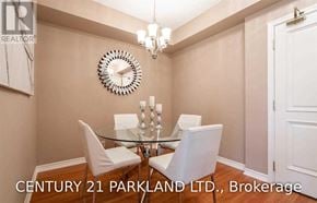 Vaughan (Maple) condo for rent - A dining room with a glass table and white chairs.