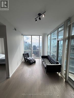 Toronto (Church-Yonge Corridor) condo for rent - A spacious room with a view of the cityscape outside the large windows.