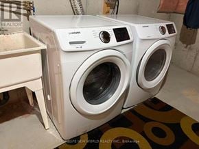 Ajax (South East) townhouse for rent - Two white Samsung front load washing machines in a laundry room.