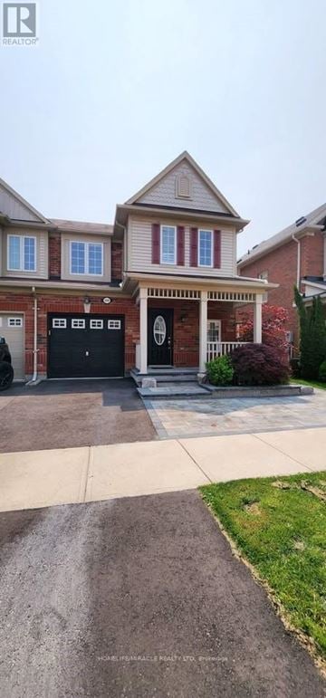 Milton (Ha Harrison) townhouse for rent - A house with a red brick exterior and a black garage door.