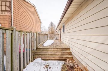 Waterloo apartment for rent - A snow-covered walkway leads to a house with a sign that reads "REALTOR".