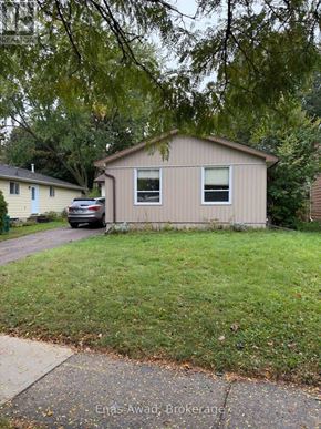 Waterloo apartment for rent - A beige house with a car parked in front.