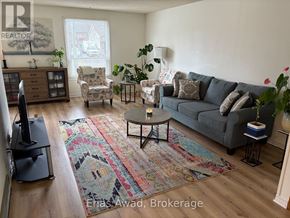 Waterloo apartment for rent - A living room with a grey couch, a coffee table, and a rug.
