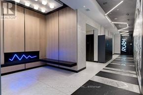 Toronto (Waterfront Communities) condo for rent - A hallway with a blue light on the wall and a sign that says "RE/MAX ESCARPMENT REALTY INC., Brokerage".