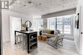 Toronto (Waterfront Communities) condo for rent - A modern living room with a bar area and a couch.