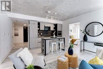 Toronto (Waterfront Communities) condo for rent - A modern living room with a grey couch and a coffee table.