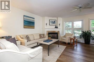 Collingwood townhouse for rent - A living room with a fireplace and a painting on the wall.
