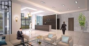 Toronto (South Parkdale) condo for rent - A man in a suit is sitting on a couch in a modern office lobby.