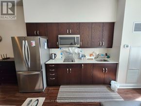 Markham (Milliken Mills East) condo for rent - A kitchen with a refrigerator, microwave, and sink.