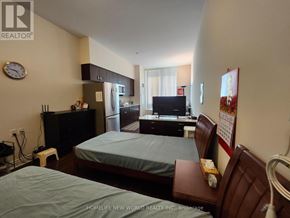 Markham (Milliken Mills East) condo for rent - A bedroom with two beds, a television, and a refrigerator.
