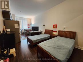 Markham (Milliken Mills East) condo for rent - A bedroom with two beds and a refrigerator.