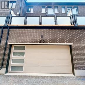 Markham townhouse for rent - A garage door with the number 312 on the wall above it.