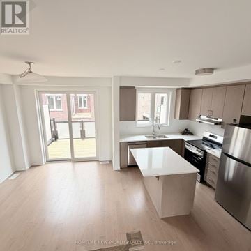 Markham townhouse for rent - A modern kitchen with a large island in the middle.