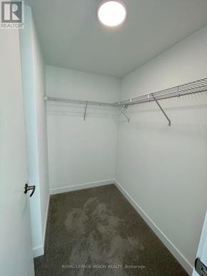 Toronto (Humber Heights) condo for rent - A white hallway with a metal rack on the wall.