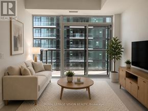 Toronto (Humber Heights) condo for rent - A living room with a couch, a coffee table, and a television set.