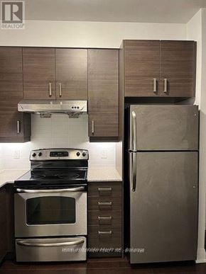 Markham (Unionville) condo for rent - A modern kitchen with a stainless steel refrigerator and stove.