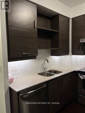 Markham (Unionville) condo for rent - A kitchen with brown cabinets and a white countertop.