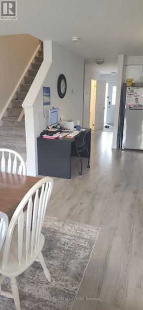 Norfolk (Simcoe) townhouse for rent - A white chair is in front of a table with a laptop on it.