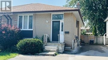 Mississauga (Clarkson) apartment for rent - A house with a white door and a small front yard.