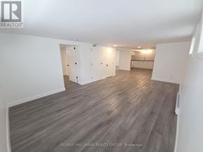Casselman apartment for rent - A spacious room with wood flooring and white walls.