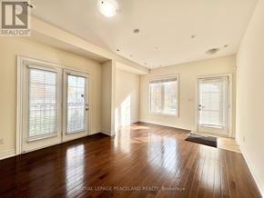 Toronto (Bridle Path-Sunnybrook-York Mills) townhouse for rent - A spacious room with wooden flooring and white walls.