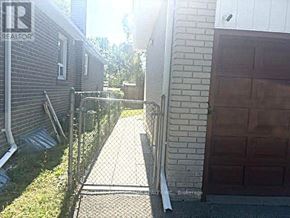 Toronto (Bendale) apartment for rent - A backyard with a fence and a garage door.