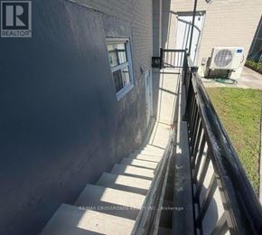 Toronto (Bendale) apartment for rent - A concrete staircase leading to a door with a window.